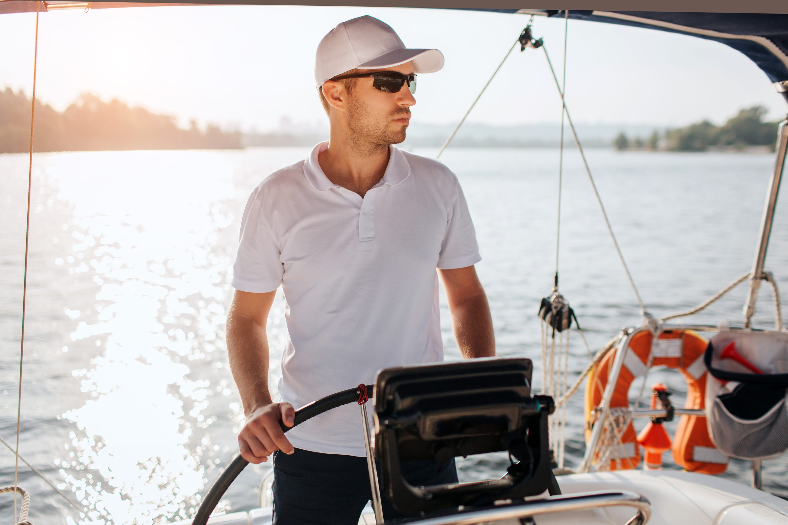 Kapitán riadi loď na mori počas rekreačnej plavby